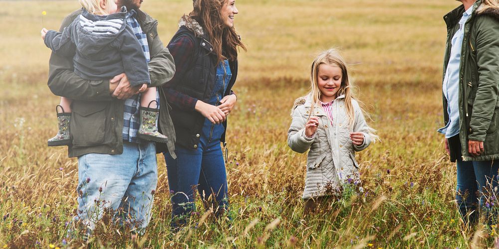 Happy family walking in a field