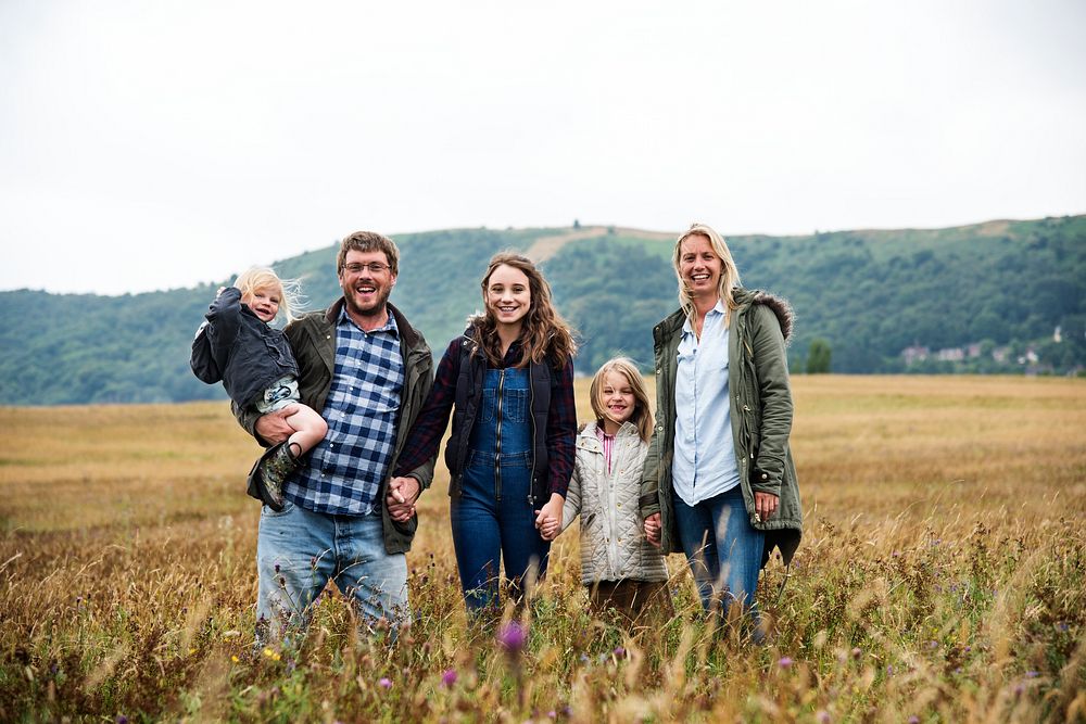 Happy family walking in a field