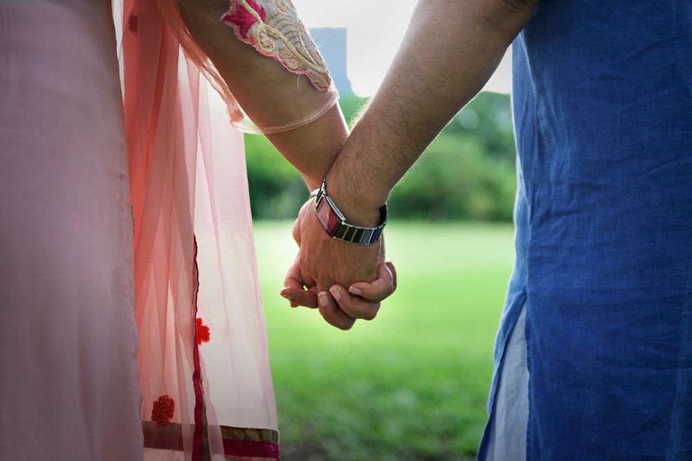 Loving senior Indian couple holding hands
