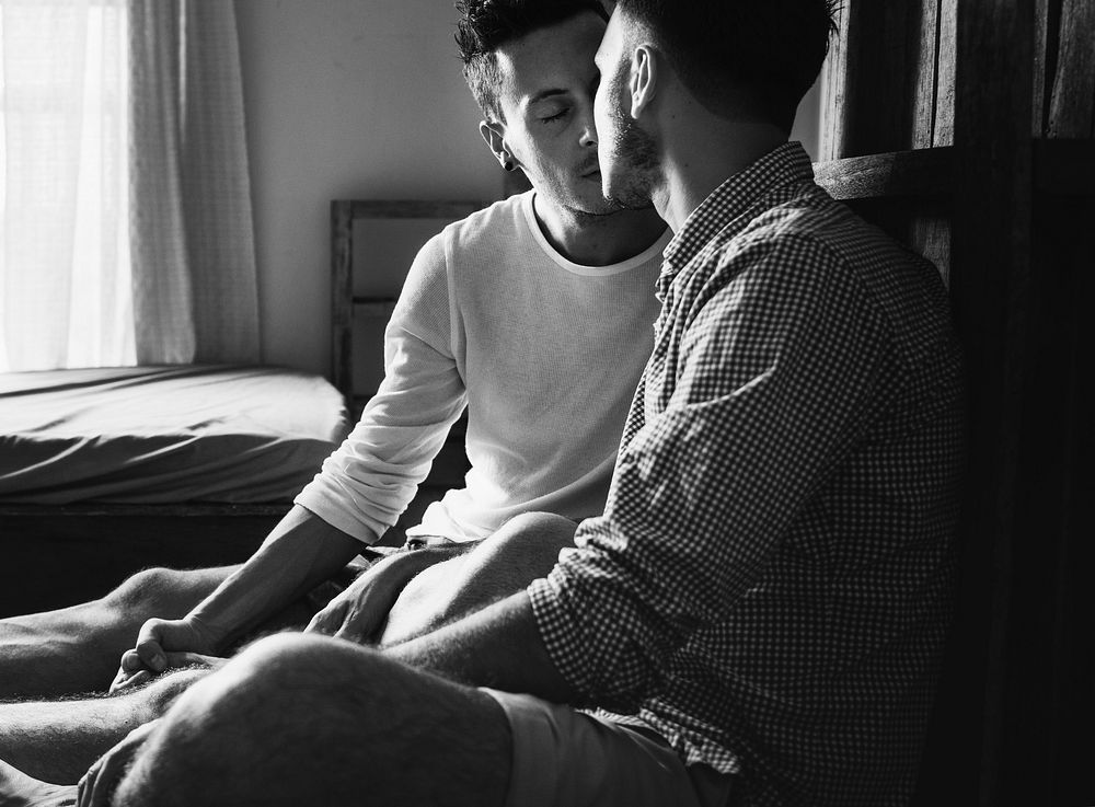 Sweet gay male couple close together