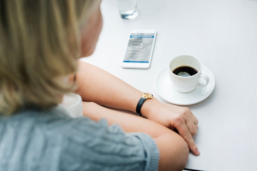 Rear view of woman sitting in a coffee cafe