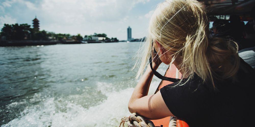 Female photographer riding a boat