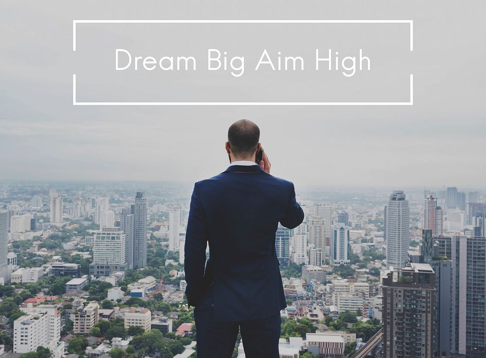 Dream big aim high overlay on businessman in the city