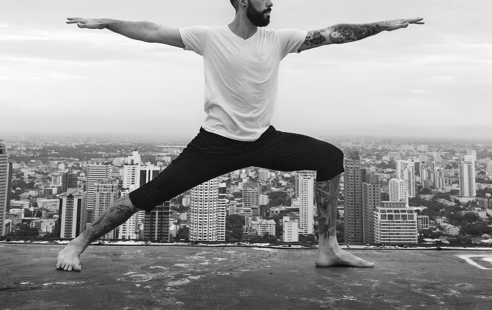 Man practicing yoga on the rooftop