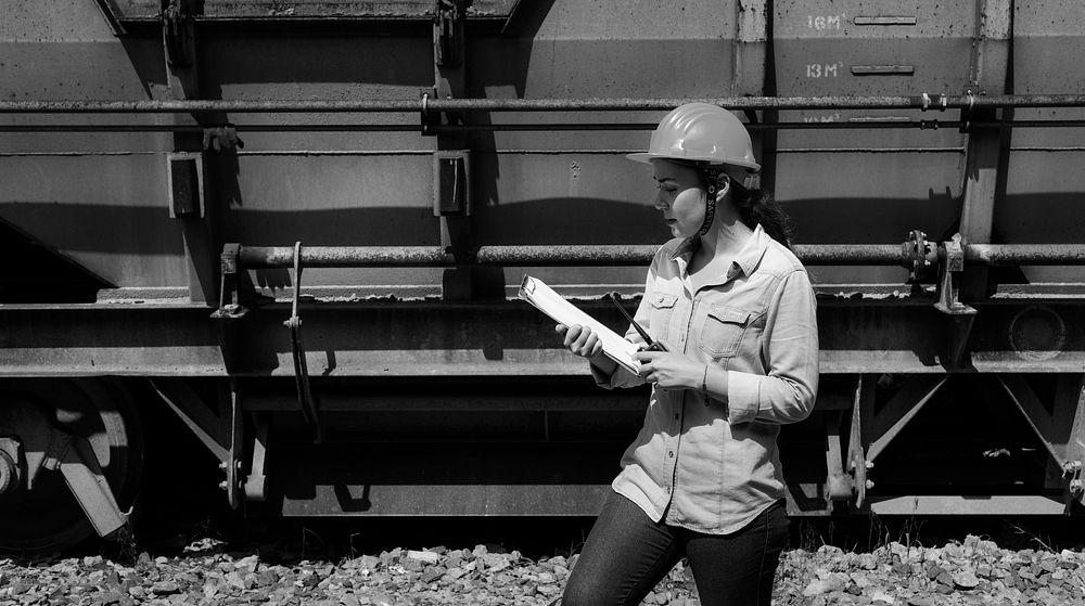 Female inspector at railroad tracks