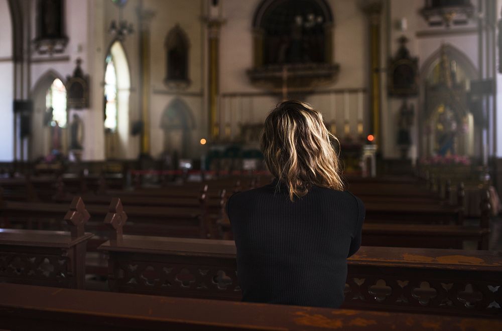 Woman praying in the church