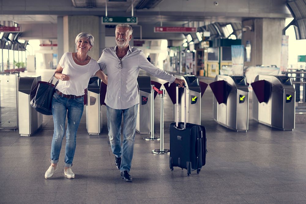 Senior couple traveling train ticket gate