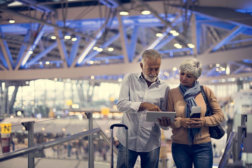 Senior couple traveling airport scene