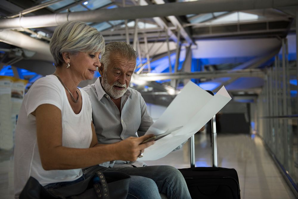 Senior couple traveling airport scene