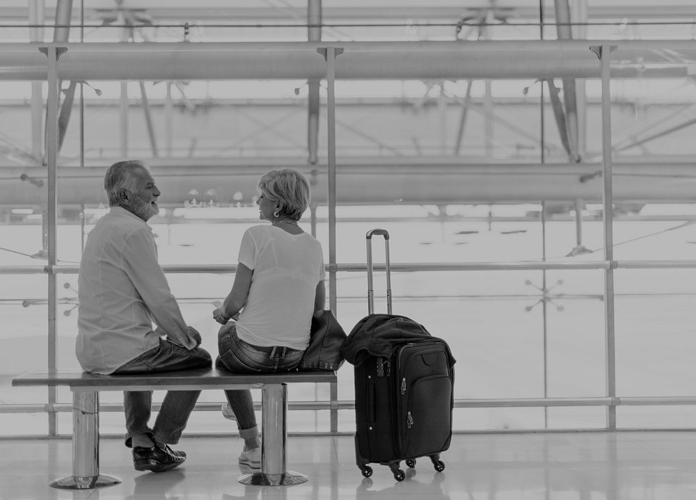 Senior couple waiting for boarding inside airport