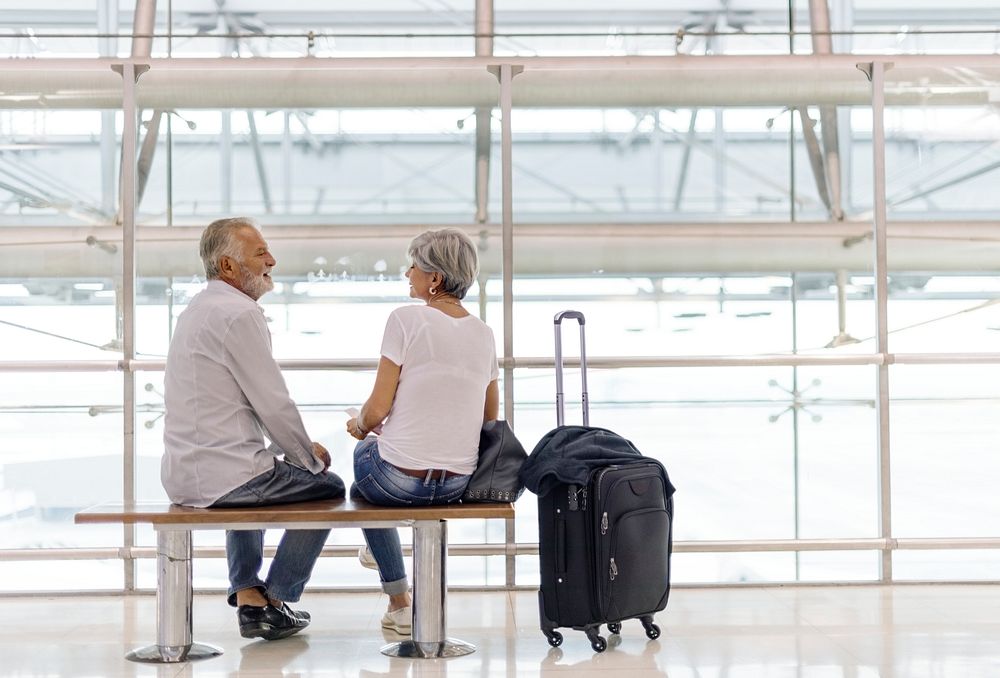 Senior couple waiting for boarding inside airport