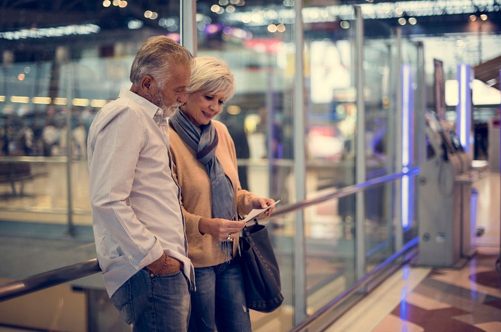 Senior couple traveling airport scene