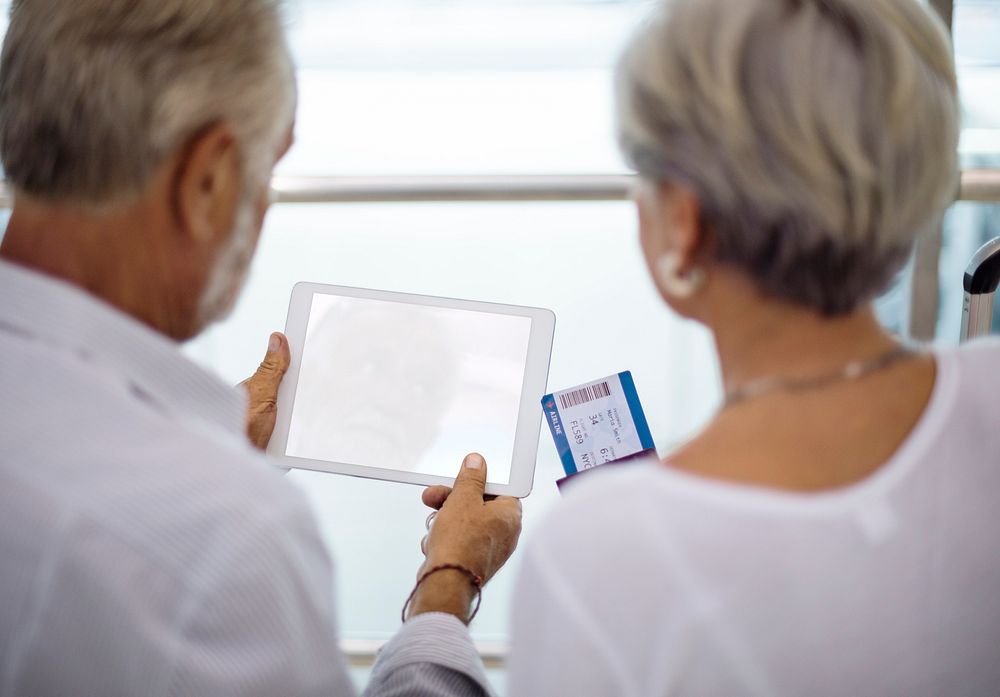 Senior couple looking at tablet copy space