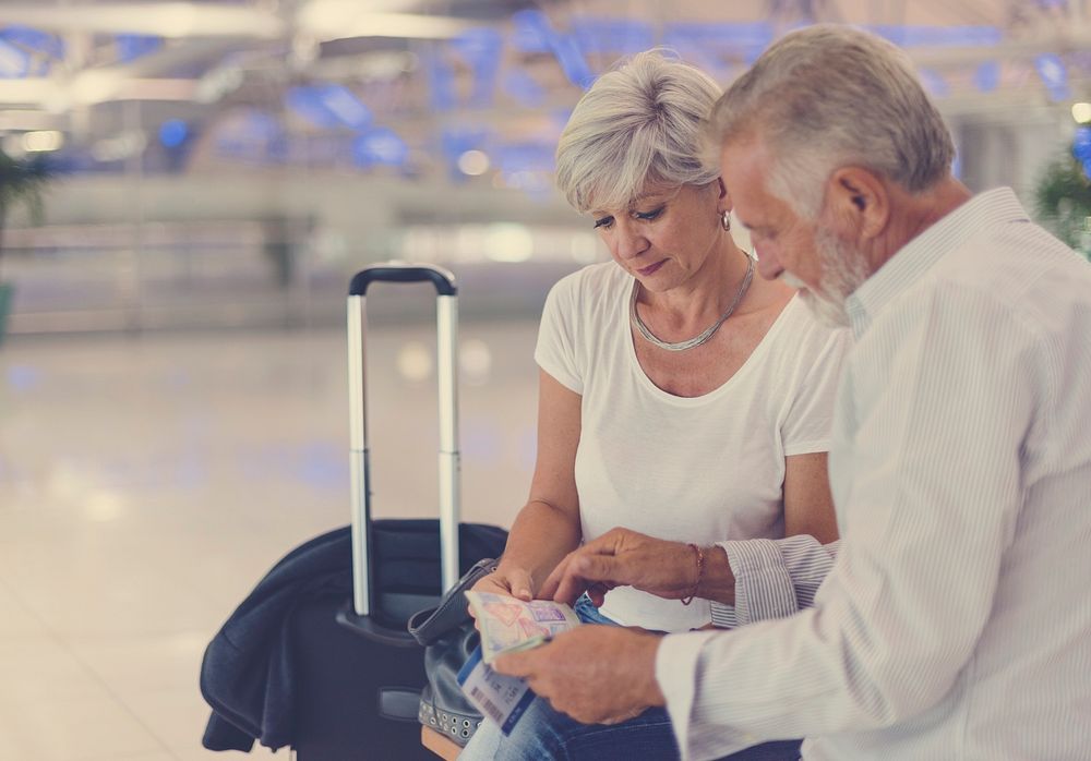 Senior couple traveling airport scene