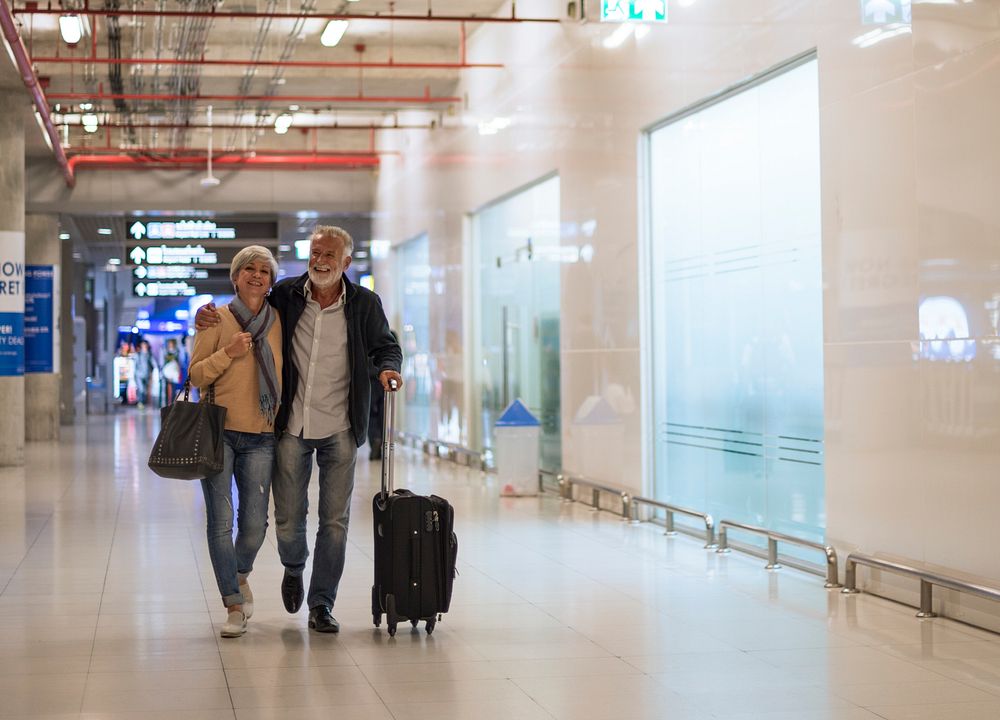 Senior couple traveling airport scene