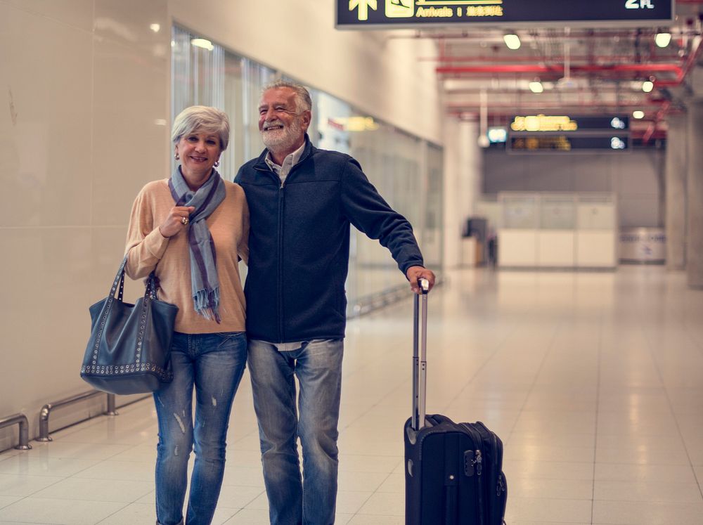 Senior couple traveling airport scene