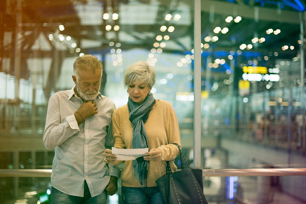 Senior couple traveling airport scene