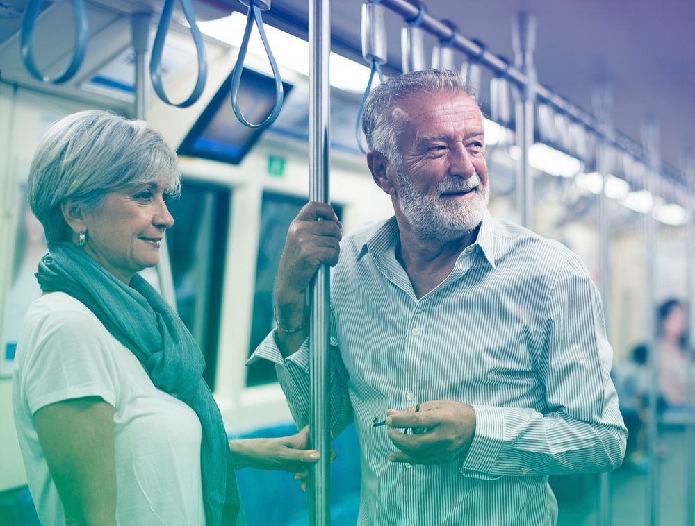 Senior couple traveling inside train subway
