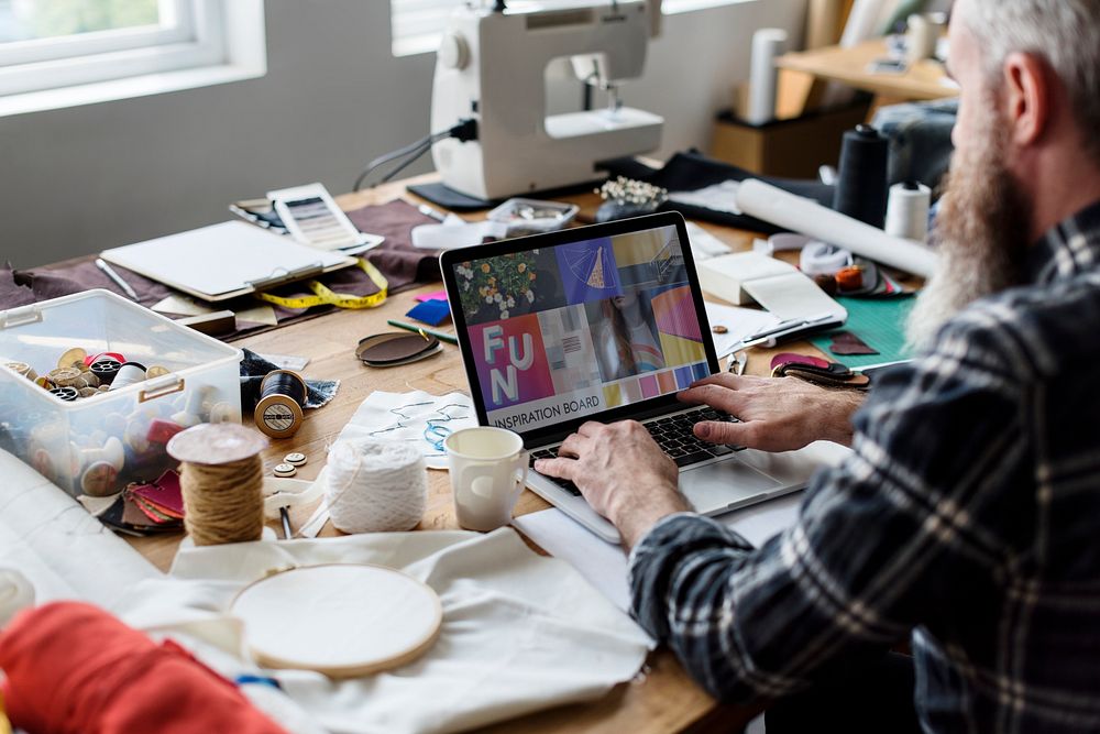 Fashion Designer working using his laptop