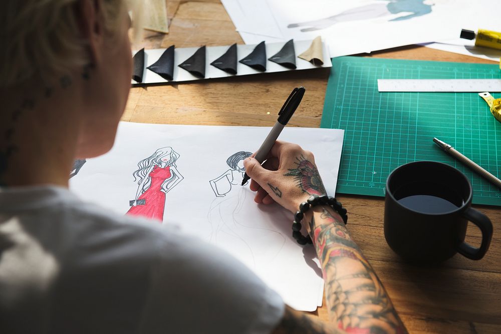 Fashion designer drawing, working in a studio