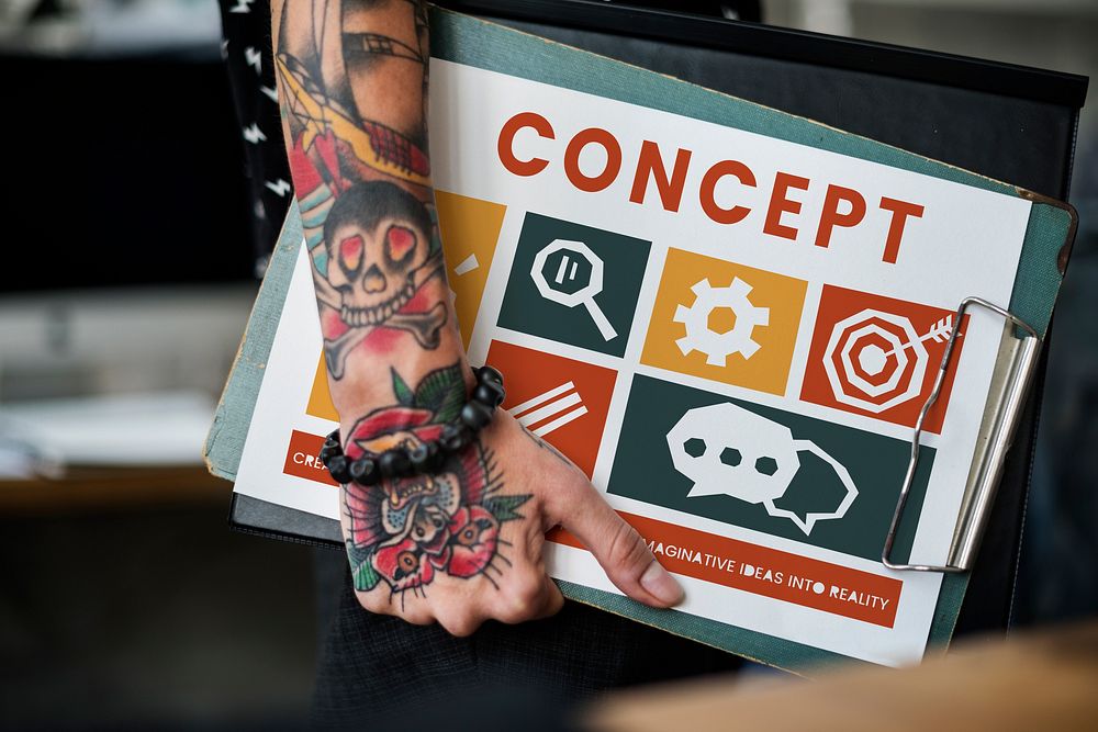 Tattooed hand with different icons on a clipboard