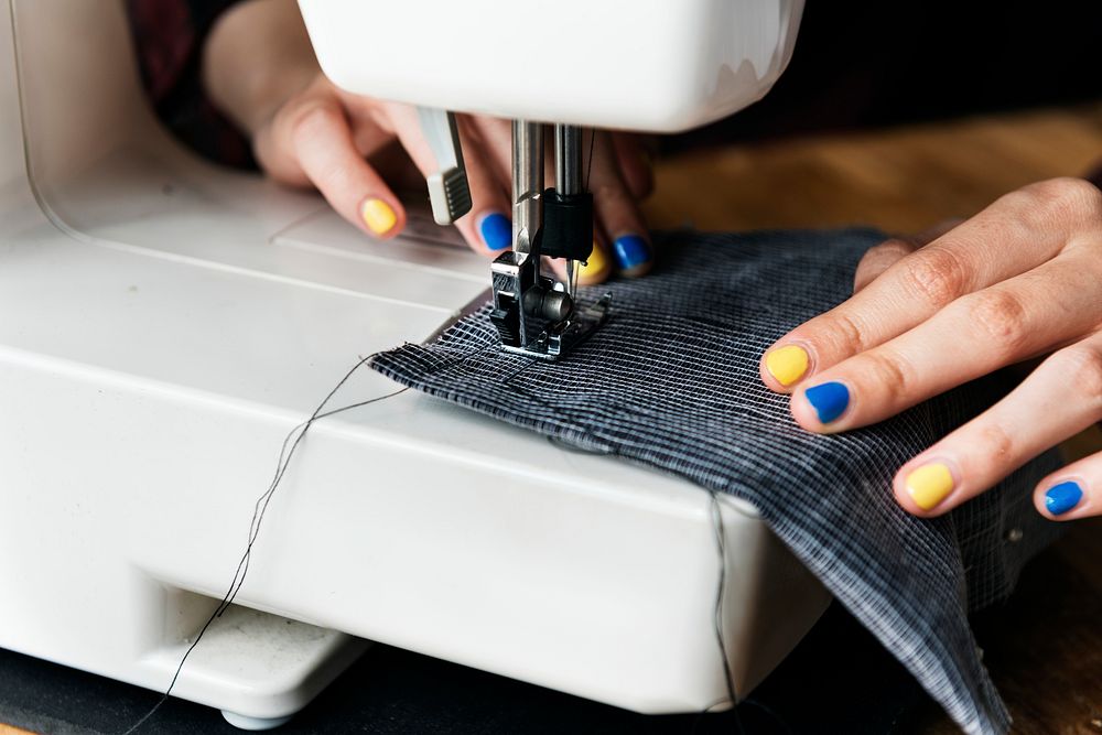 Fashion designer using a sewing machine