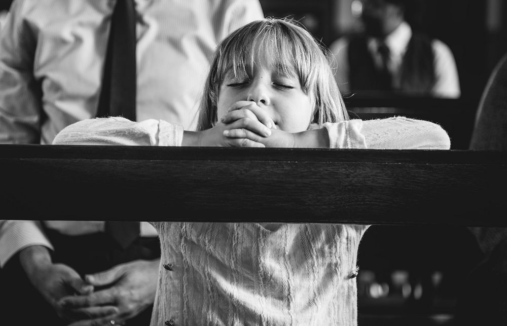 A child praying inside the church