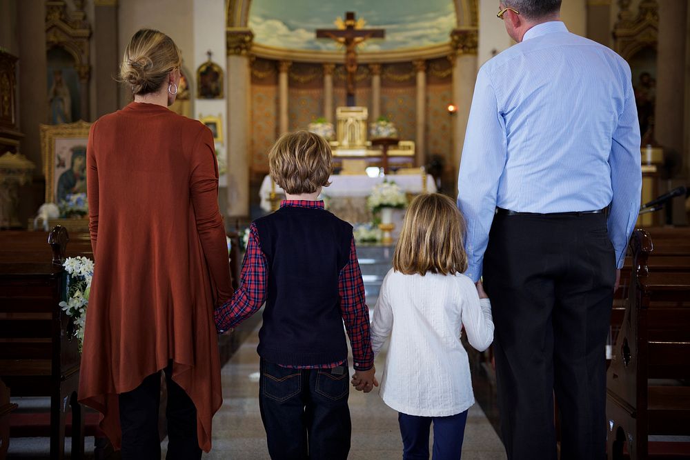 A family praying together inside a church
