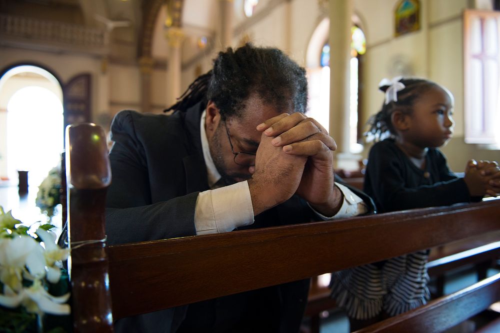 Religious man praying inside a church