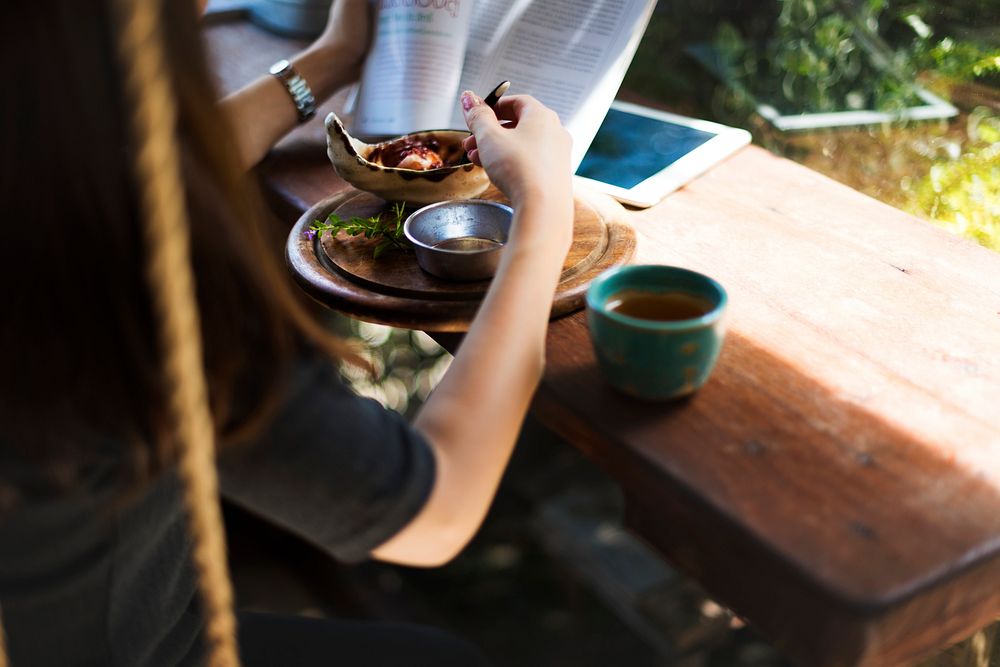 Woman eating while reading a book