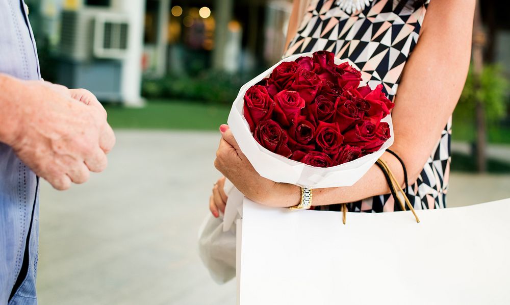 Mature couple woman bouquet of flowers