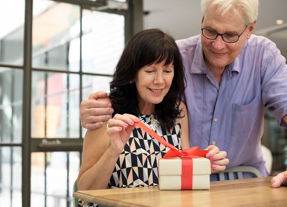 Husband giving wife a box present