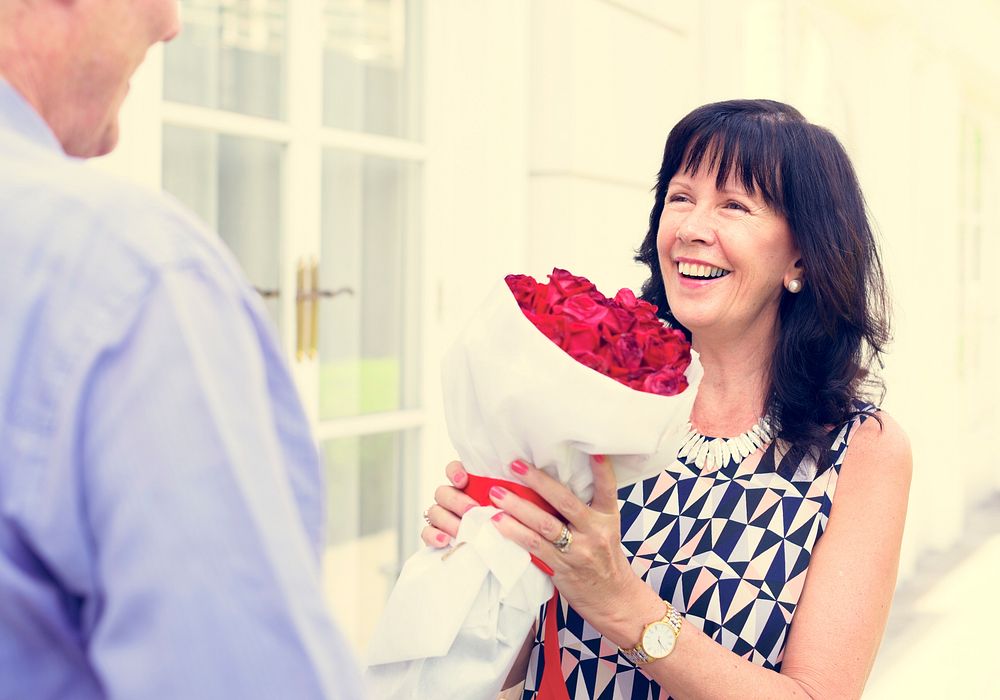 Senior woman holding bouquet of roses