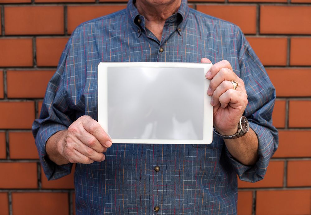 Senior man holding a digital tablet