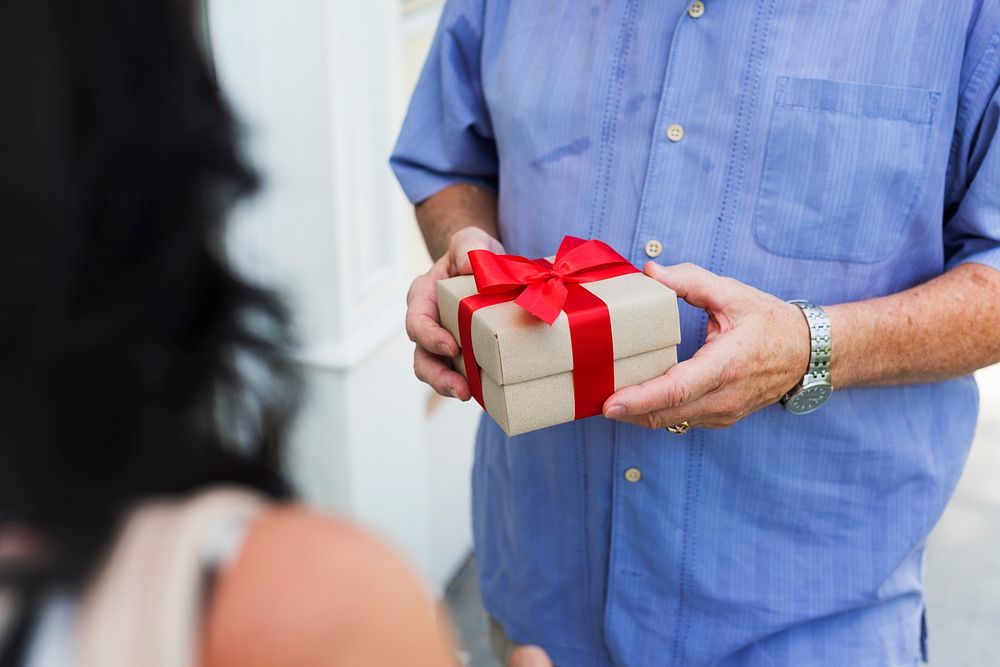 Husband giving wife a box present