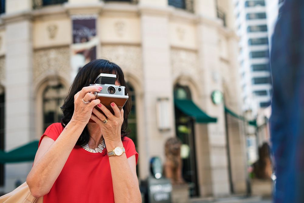 Woman taking photo using vintage camera