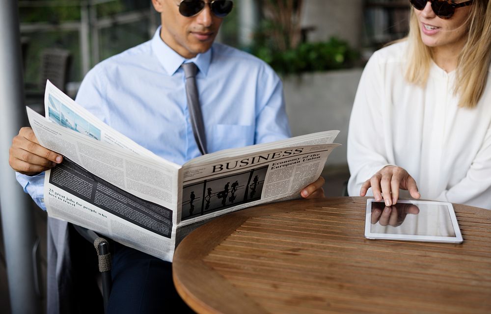 Businessmen Reading Newspaper Women Use Tablet