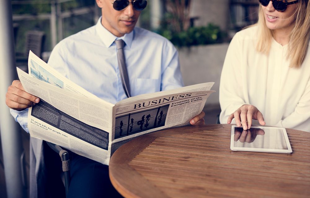 Businessmen Reading Newspaper Women Use Tablet