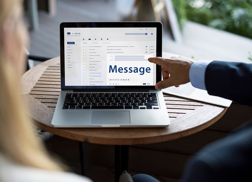 Hands composing an email on a digital device