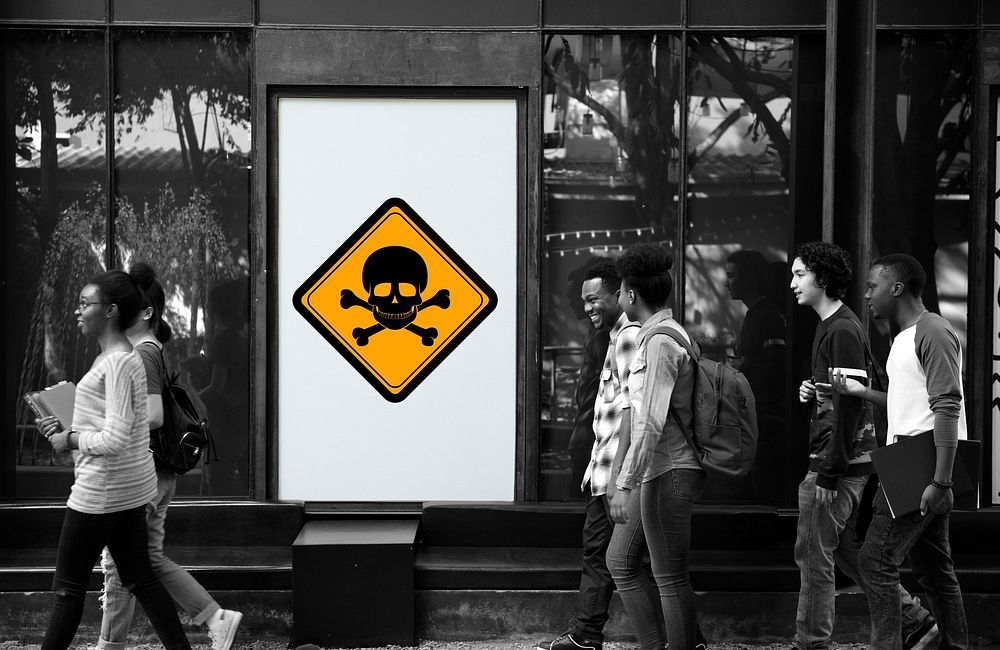 Group of People Walking with Poison Danger Sign Banner Behind