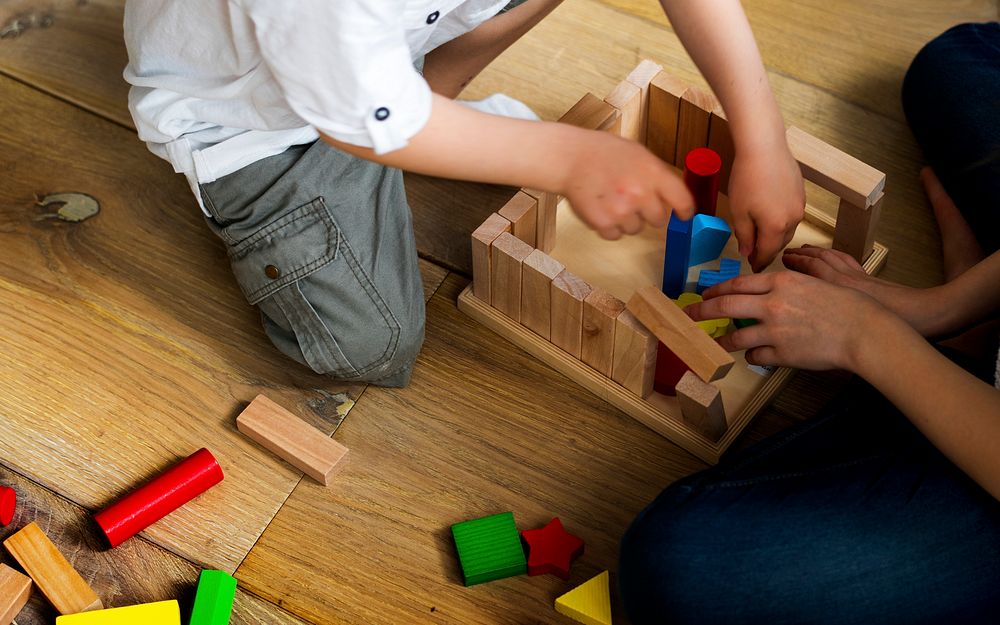 Little kids playing with toy blocks