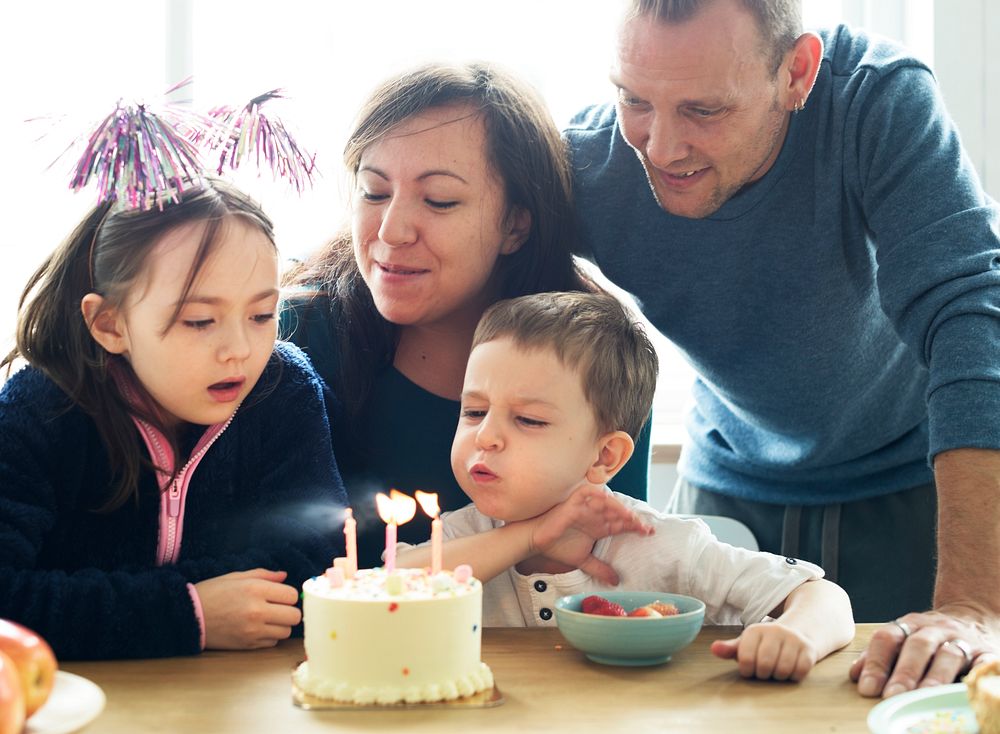 Kid celebrating birthday with his family