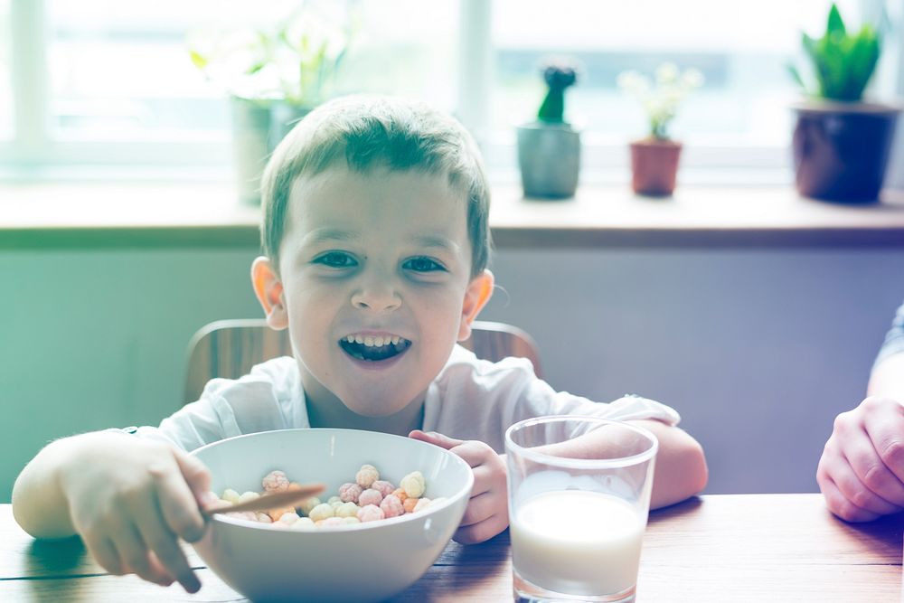 Little Boy Enjoying Bowl Of Cereal