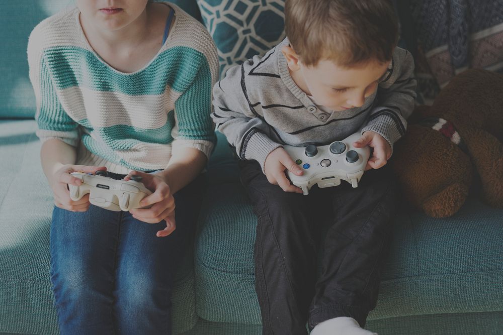 Little children having fun playing video games