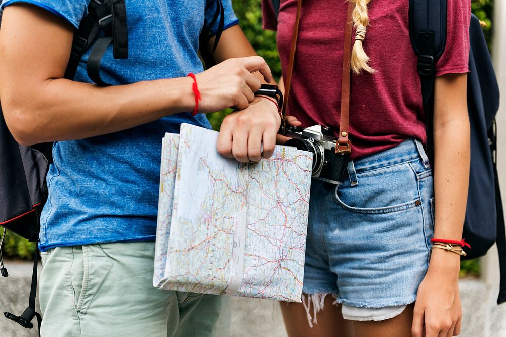 Couple traveling with map checking time