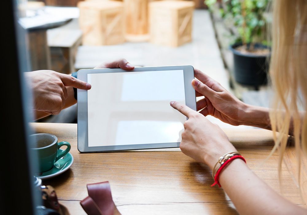 Couple using digital tablet in a cafe