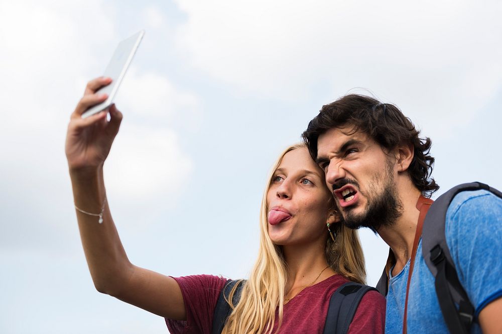 Couple taking a wacky selfie tongue out