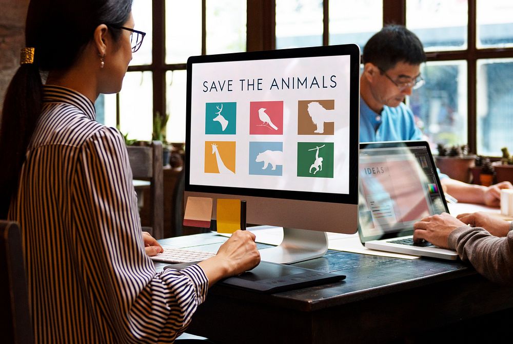 Busy casual office with save animals on the computer