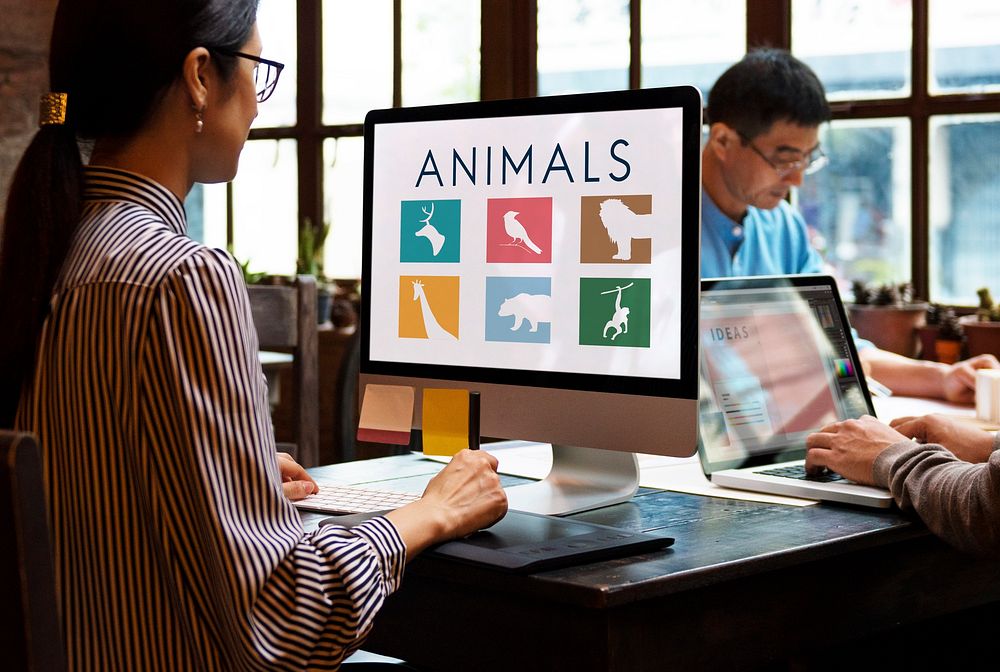Busy casual office with save animals on the computer