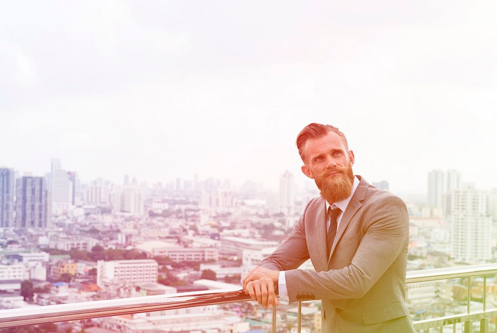 Professional businessman posing on footbridge cityscape